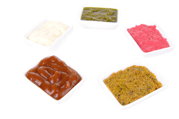 Various sauces isolated on white