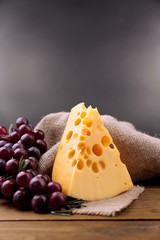 Piece of cheese with grape and rosemary