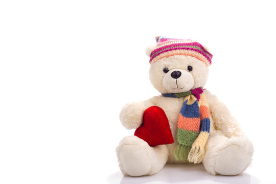 Toy teddy bear sitting with valentine heart