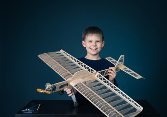 Happy boy has holding the model airplane