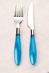 Fork and knife on pink napkin. Cutlery