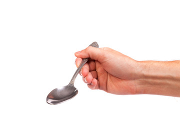 Hand is holding a spoon isolated - obrazy, fototapety, plakaty