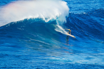 Surfer riding giant wave