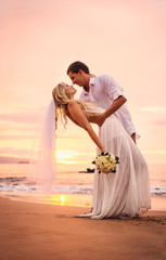 bride and groom on beach at sunset - 60963229