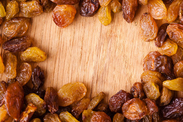 Diet healthy food. Border of raisin on wooden background