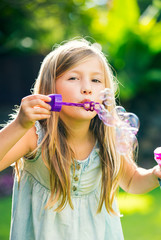 little girl with soap bubbles