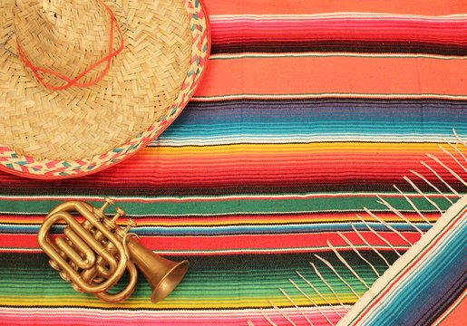 Mexican poncho sombrero poncho with mariachi trumpet sombrero cinco de mayo background mexico fiesta copy space pattern stripes copy space serape stock, photo, photograph, picture, image, 