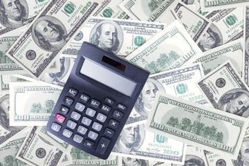 Calculator and dollar banknotes