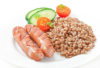 sausages on the grill and buckwheat