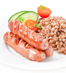 sausages on the grill and buckwheat
