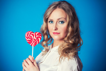 Beautiful young woman with lollipop
