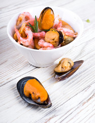 Mussels and shrimp in a white cup, seafood