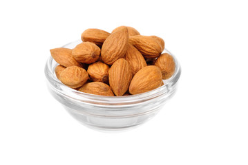 Dried almonds on glass bowl isolated on a white background
