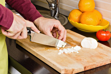 Closeup of man hands cutting vegetables