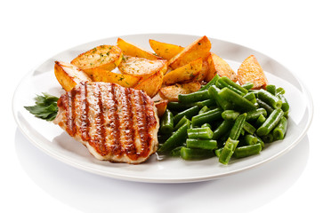 Grilled steak, baked potatoes and vegetables