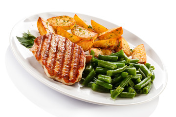Grilled steak, baked potatoes and vegetables