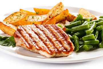 Grilled steak, baked potatoes and vegetables