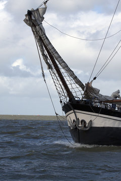 Front of a vintage wooden sailboat on the ijsselmeer.