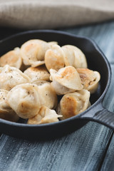 Fried pelmeni or meat dumplings, close-up