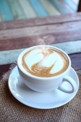Hearts latte art coffee cup on grunge wood table