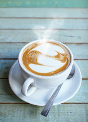 Hearts latte art coffee cup on grunge wood table