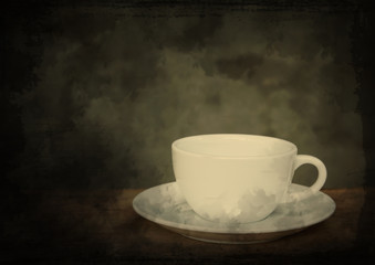 Cup of coffee on grunge wood table in vintage style