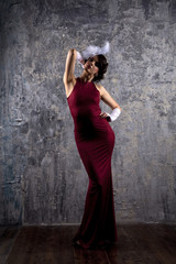 Fototapeta na wymiar Fashion model in long red dress