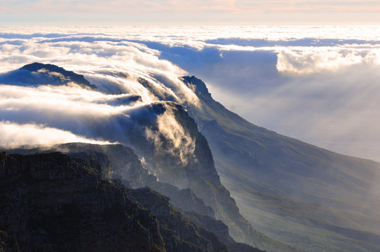 View of magnificent Table mountain covered in cloud blanket at sunset, Cape Town, South Africa