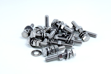 Steel nuts and bolts isolated on white