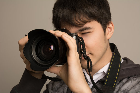 Portrait of photographer using professional camera