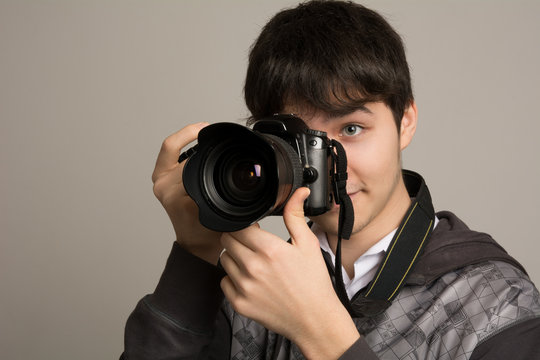 Male photographer taking photos with DSLR digital camera