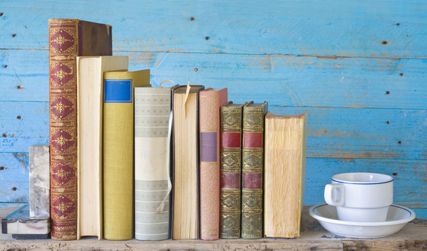row of vintage books, with coffee cup, free copy space