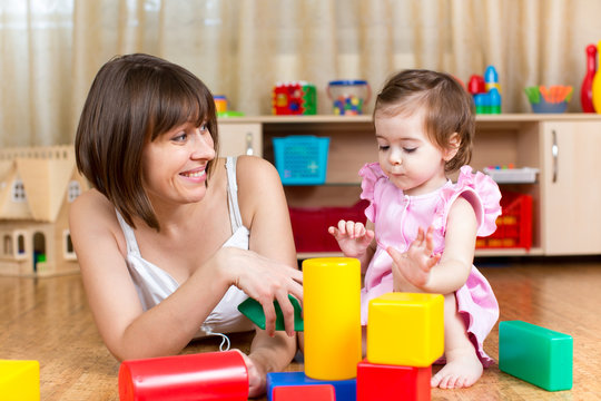 mom and kid play toys indoors