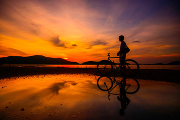 Fototapeta na wymiar Silhouette cyclist with reflection
