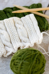 Knitting pattern and needles on a wooden background