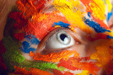 close up photo of female eye with paints