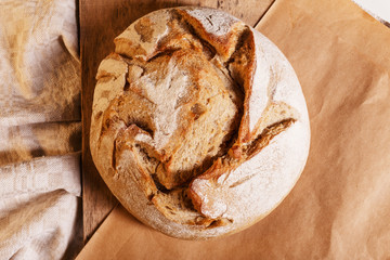A round homemade loaf on paper