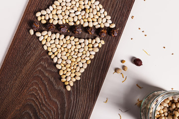 Uncooked beans on a piece of wood