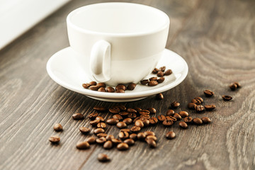 A neat white cup and coffee beans