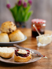 Scones prepared with clotted cream and jam
