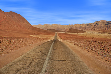Road and red mountains in Timna park.