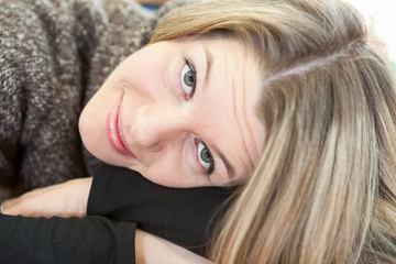 Face of attractive woman laying on clasped hands