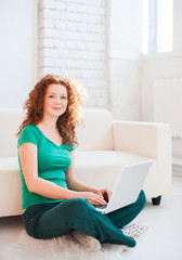 Young woman using a laptop computer at home