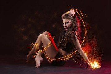 young girl dancing with fire