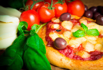 Homemade pizza with basil and olives