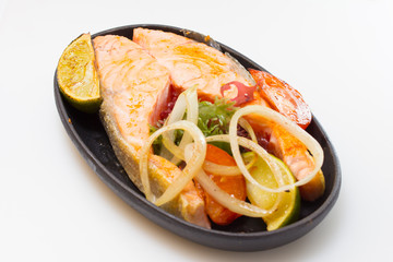 Raw salmon fillet with vegetables on white background
