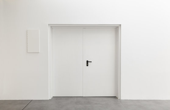 White door in a white room