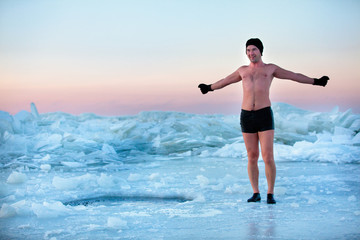 Man is going to swimm in an ice-hole - obrazy, fototapety, plakaty