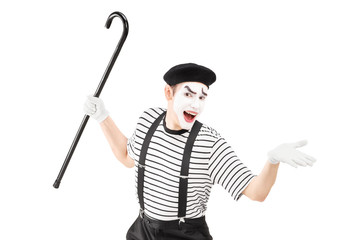 Mime artist holding a cane and gesturing