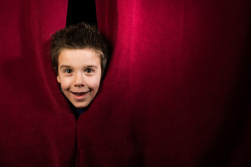 Child appearing beneath the curtain - Powered by Adobe